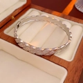 Vista detallada de brazalete plateado con diseño de rombos y circonitas en estuche - Plateado