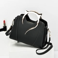 Chic black handbag with cat-ear metal handles and contrasting white stitching details - Black