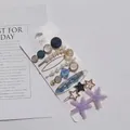 Golden hair clip set with pearls and star shapes on a clean white display card - Starfish 8-Piece Set