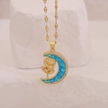 Goldene Mondhalskette mit blauem Opal-Inlay und Goldrose auf weißem Steinuntergrund - Rose