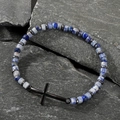 Men's natural blue stone bead bracelet with black cross charm on a grey stone slab - Blue and White Stone Cross Black Accessory Bracelet (B-B24061206A)