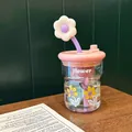 Close-up of heat-resistant floral glass bottle with pink tea filter and flower straw lid - Pink