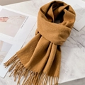 Brown pure wool scarf with tassel fringe neatly folded on marble surface - Dark Camel