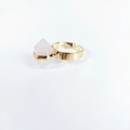 Detail view of pink hexagonal crystal stone set on a golden adjustable open ring band - Rose Quartz