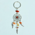Dreamcatcher keychain with orange natural crystals and silver feather charms on blue background - Red Agate