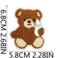 Detailed view of brown teddy bear chenille patch with dimensions 6.8x5.8cm on white back - Style 6 (Teddy Bear with Milk Bottle)