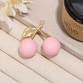 Close-up of pink cherry bag pendant with golden metal leaves and decorative beads - Pink