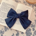 Elegant navy blue satin oversized bow hair clip on a vintage book background - Hair Bow / Navy Blue