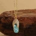 Golden flip-flop pendant necklace with blue evil eye enamel and white zircon stones - Blue Evil Eye