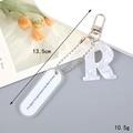 Detail view of marble pattern letter R keychain with acrylic charm and tulip card background - Letter R