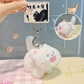 White fluffy cat plush keychain with blue eyes and silver bell on pink checkered pattern - White-Basic