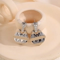 Silver geometric shield earrings with sparkling crystals on beige ceramic display - Silver Textured Rhinestone