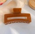 Detail of a large caramel brown hair claw clip on a soft satin surface for thick hair styling - 13cm Jelly Rectangular - Brown / Bulk (No Packaging)