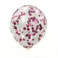 Close-up of transparent latex balloon filled with vibrant magenta round foil sequins - Pink Sequin