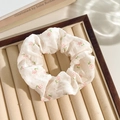 White floral lace scrunchie with pink flowers pattern on beige jewelry display tray - Pink Flower