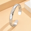 Bracciale rigido aperto con trama martellata barocca in acciaio inossidabile finitura argento - Color Acciaio