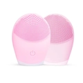 Macro detail of pink silicone facial cleanser showing soft bristles and power button - Pink