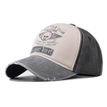 Close-up of vintage washed cotton baseball cap with distressed brim and skull print - Black Skull