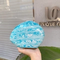 Macro shot of marble textured oval evening clutch bag with glossy light blue finish - Sky Blue