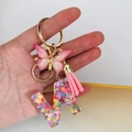 Close-up of resin letter N keychain with pink butterfly, tassel and heart sequins - Butterfly Tassel 8-Shape Buckle / Letter N