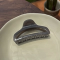 Detail of grey translucent butterfly clip on ceramic plate with natural decor - Light Silver Grey