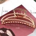 Macro view showing dimensions of large gold hollow alloy hair claw clip on magazine - Large Crescent Claw / 11cm / High Shine Gold