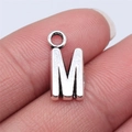 Silver alloy M-shaped letter charm pendant for DIY jewelry on a person fingertip - Letter M (B15666) / Antique Silver