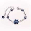 Silver-toned flower bracelet with deep blue pear-cut crystals and adjustable lobster clasp - Royal Blue-White Gold