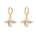 Macro view of bee-shaped drop earrings with pavé zircons and pear-shaped stones - Gold Bee