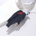 Détails d'une pince à cheveux aigle noir avec tête blanche et accents d'ailes rouges - Aigle