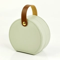 Portable mint green leather jewelry box with a brown handle and gold button - PU Leather / Round Handheld Style / Handheld Light Green