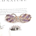 Pince à cheveux élégante en or rose avec strass violets et clairs, motif nœud - Ruban / Violet