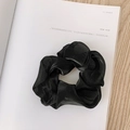 Elegant large black organza scrunchie with sheer texture on a minimalist magazine background - Pearly Satin Black