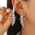 Silver swallow bird stud earrings with textured feather detail on female model - Silver Stud Earrings