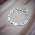 Detail of woven stainless steel snake chain with lobster clasp on satin background - Bracelet / Silver