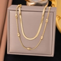 Elegant gold double-layered necklace featuring a snake chain and delicate oval beads - Bead + Blade / Gold