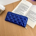 Detail of dark blue patent leather wallet with quilted diamond stitching and gold zipper - Blue