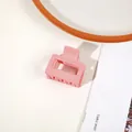 Pink matte rectangular claw clip for women on a decorative plate and magazine - Matte Korean Pink