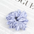 Elegant lavender satin scrunchie with pleated texture on a fashion magazine background - Aqua