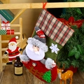 Detail of red and green plaid Christmas stocking with plush Santa and tree decor - F4-3 New Large Fence Stocking - Santa