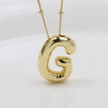 Macro shot of 3D puffy golden letter G bubble pendant necklace with polished finish - Letter G (Necklace)