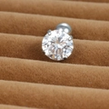 Macro view of a round brilliant-cut gemstone stud earring with four-prong setting - 8mm Silver (E1074)