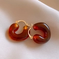 Detail of amber brown resin hoop earrings with golden metal buckle on soft fabric - 29# Amber Resin U-shaped Ear Clip