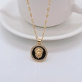 Macro detail of lion head pendant with gold plating, black enamel, and clear crystals - Black / Lip Chain
