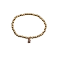 Detail of a gold bead bracelet with a crystal-encrusted letter B pendant and colorful stones - Letter B