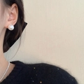 Close-up of elegant white pearl earrings and necklace worn by a woman for a chic look - Shell Pearl / 12mm / Silver