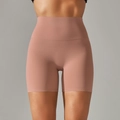 Detail view of high-waisted yoga shorts in coral pink with seamless matte finish - Medium Mauve