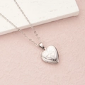 Silver heart locket necklace with double heart engraving on a pink textured background - Steel Small Double Hearts (22*19mm)