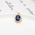 Detailed view of an oval blue crystal pendant with micro-pave zircon and a gold-plated rim - Oval Dark Blue / 11*15mm