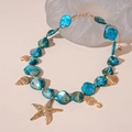 Detailed close-up of a blue beaded ocean necklace with gold starfish and shell pendants - Blue Ocean Creature Beaded Multi Pendant Necklace
